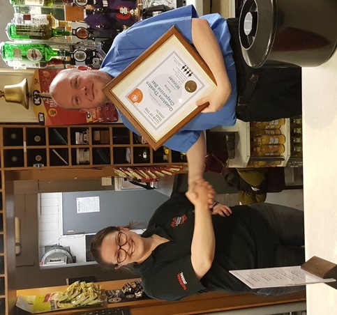 Cecily Johnson receives the award from Thomas Black